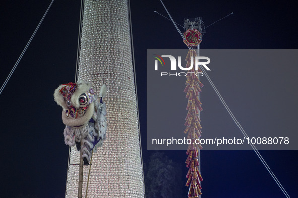 A lion dancer in front of the bun tower on May 26, 2023 in Hong Kong, China. Cheung Chau Bun Festival or Cheung Chau Da Jiu Festival is a tr...