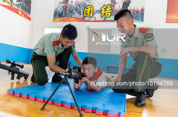 A student experiences armed police equipment in Yulin city, South China's Guangxi Zhuang Autonomous region, May 31, 2023. 