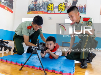 A student experiences armed police equipment in Yulin city, South China's Guangxi Zhuang Autonomous region, May 31, 2023. (