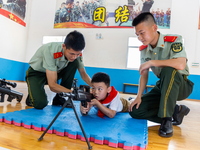 A student experiences armed police equipment in Yulin city, South China's Guangxi Zhuang Autonomous region, May 31, 2023. (