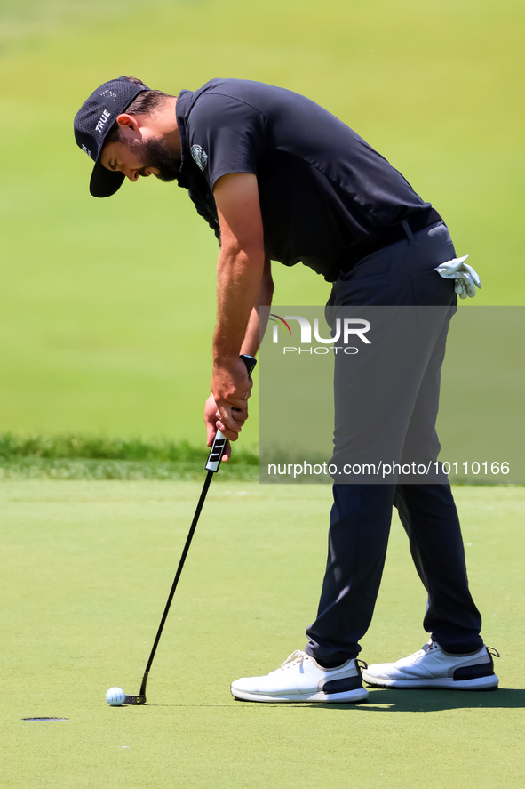 Mark Hubbard of Denver, Colorado taps in his ball on the 18th green during the first round of the The Memorial Tournament presented by Workd...