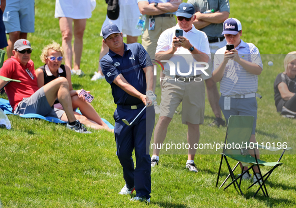 Jason Dufner of Auburn, Alabama chips from the rough in the seating area onto  the 18th green during the first round of the The Memorial Tou...