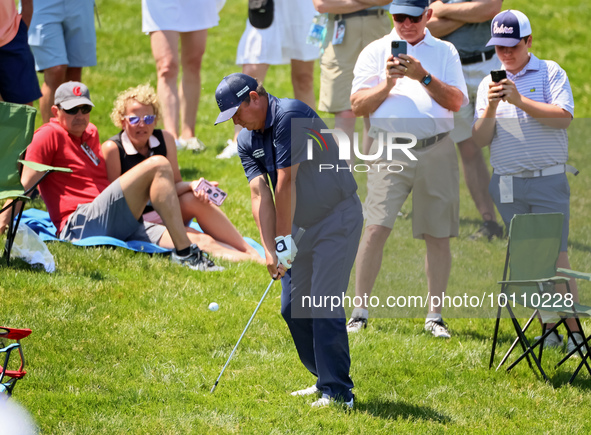 Jason Dufner of Auburn, Alabama chips from the rough in the seating area onto  the 18th green during the first round of the The Memorial Tou...