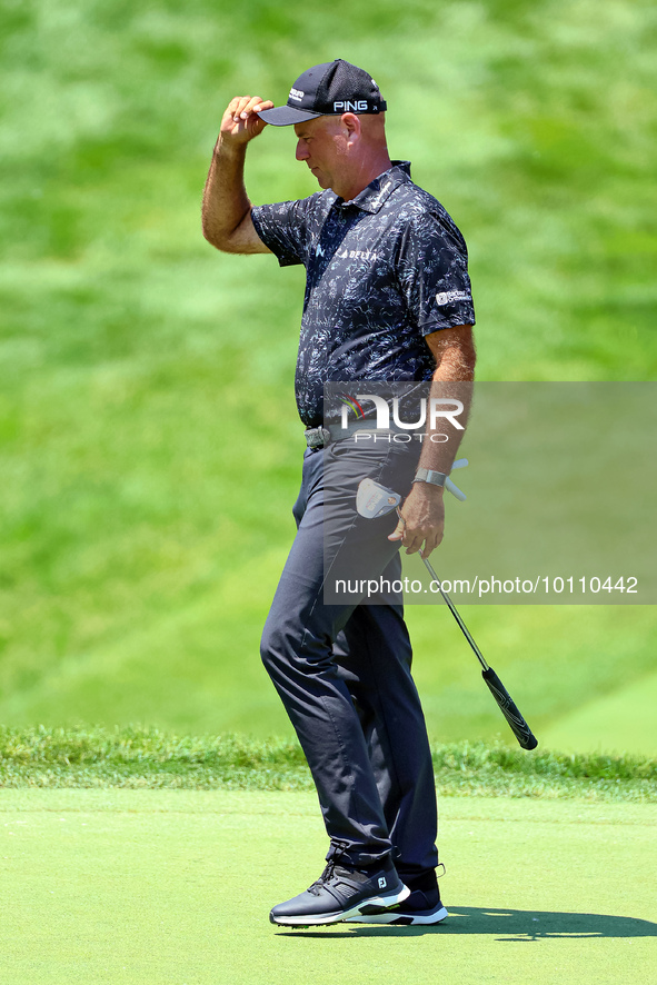 Stewart Cink walks off the course after completing his putt on the 18th green during the first round of the The Memorial Tournament presente...