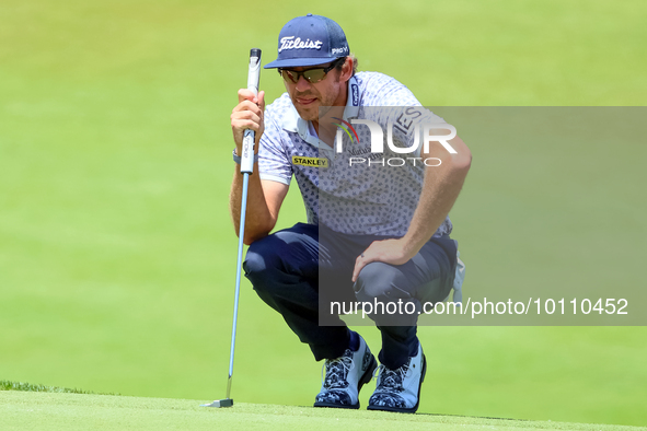 Lanto Griffin of Jacksonville Beach, Florida lines up his putt on the 18th green during the first round of the The Memorial Tournament prese...