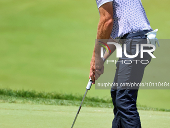 Lanto Griffin of Jacksonville Beach, Florida lines up his putt on the 18th green during the first round of the The Memorial Tournament prese...