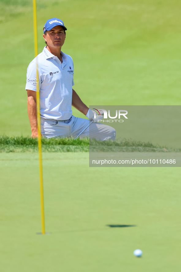 Kevin Kisner of Aiken, SC follows his chip from the sand trap onto the 18th green during the first round of the The Memorial Tournament pres...