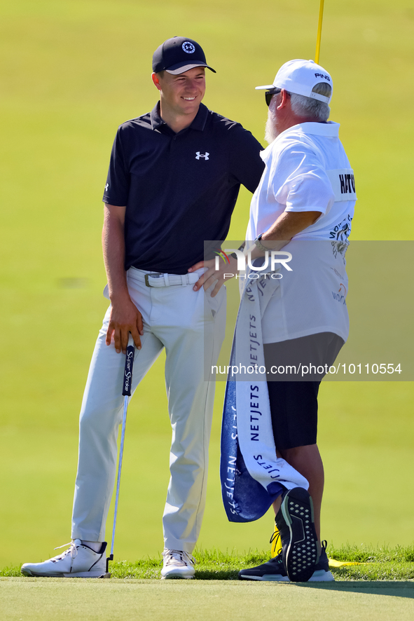 Tyrrell Hatton of High Wycombe, England talks with his caddie after putting on the 18th green during the first round of the The Memorial Tou...