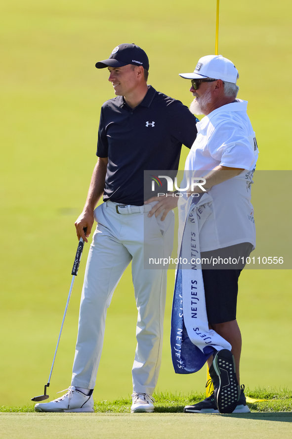 Tyrrell Hatton of High Wycombe, England stands with his caddie after putting on the 18th green during the first round of the The Memorial To...