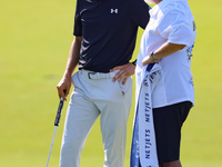 Tyrrell Hatton of High Wycombe, England stands with his caddie after putting on the 18th green during the first round of the The Memorial To...