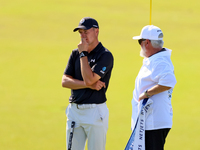 Tyrrell Hatton of High Wycombe, England waits with his caddie after putting on the 18th green during the first round of the The Memorial Tou...