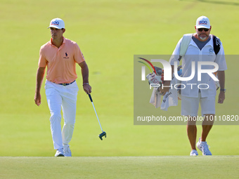 Billy Horschel of Ponte Vedra Beach, Florida walks with his caddie onto the 18th green during the first round of the The Memorial Tournament...