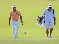 Billy Horschel of Ponte Vedra Beach, Florida walks with his caddie onto the 18th green during the first round of the The Memorial Tournament...