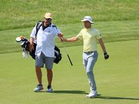 Peter Malnati of Knoxville, Tennessee passes his club to his caddie after hitting on the 17th green during the first round of the The Memori...