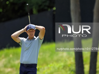 Cam Davis of Sydney, Australia reacts to his fairway shot during the first round of the The Memorial Tournament presented by Workday at Muir...