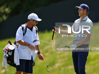 Cam Davis of Sydney, Australia passes his club to his caddie after hitting his fairway shot during the first round of the The Memorial Tourn...