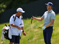 Cam Davis of Sydney, Australia passes his club to his caddie after hitting his fairway shot during the first round of the The Memorial Tourn...