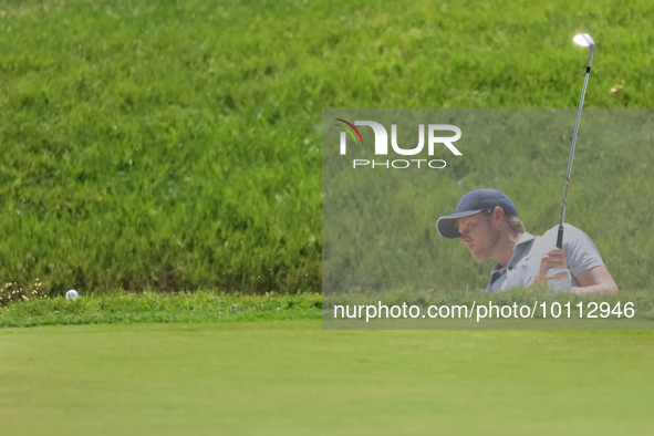 Cam Davis of Sydney, Australia chips onto the 16th green from the bunker during the first round of the The Memorial Tournament presented by...