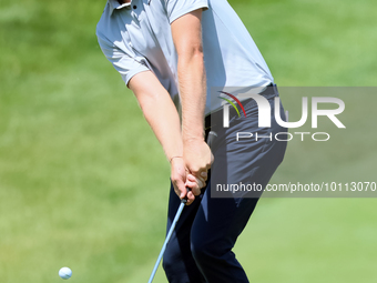 Cam Davis of Sydney, Australia follows chips onto the 18th green  from the bunker during the first round of the The Memorial Tournament pres...