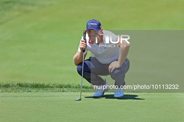 Matt Wallace of England lines up his putt on the 18th green during the first round of the The Memorial Tournament presented by Workday at Mu...