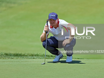 Matt Wallace of England lines up his putt on the 18th green during the first round of the The Memorial Tournament presented by Workday at Mu...