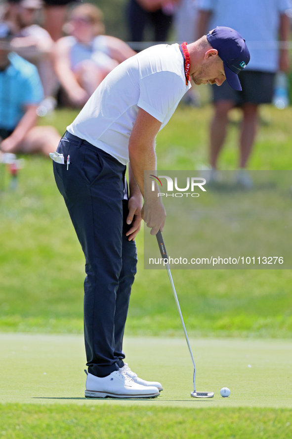 Matt Wallace of England follows putts on the 17th green during the first round of the The Memorial Tournament presented by Workday at Muirfi...