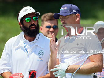 Matt Wallace of England talks with his caddie after hitting from the 16th tee during the first round of the The Memorial Tournament presente...