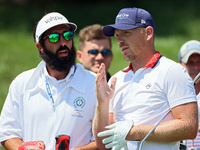 Matt Wallace of England talks with his caddie after hitting from the 16th tee during the first round of the The Memorial Tournament presente...