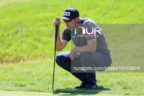 Seamus Power of Waterford, Ireland hits lines up his putt on the 15th green during the first round of the The Memorial Tournament presented...