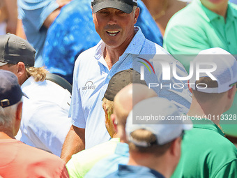 Matt Kuchar of Jupiter, Florida greets fans as he walks off the course after completing the first round of the The Memorial Tournament prese...