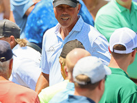 Matt Kuchar of Jupiter, Florida greets fans as he walks off the course after completing the first round of the The Memorial Tournament prese...