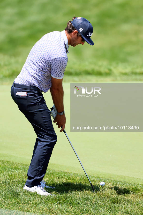 Lanto Griffin of Jacksonville Beach, Florida chips onto the 18th green during the first round of the The Memorial Tournament presented by Wo...