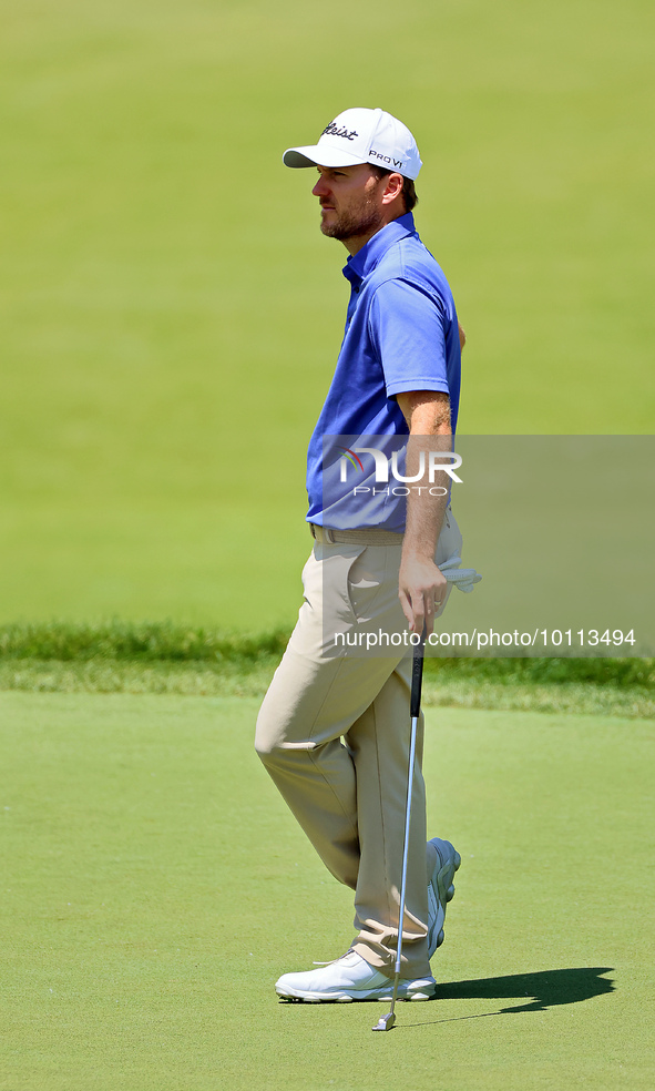 Russell Henley of Columbus, Georgia waits on the 18th green during the first round of the The Memorial Tournament presented by Workday at Mu...