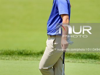 Russell Henley of Columbus, Georgia waits on the 18th green during the first round of the The Memorial Tournament presented by Workday at Mu...