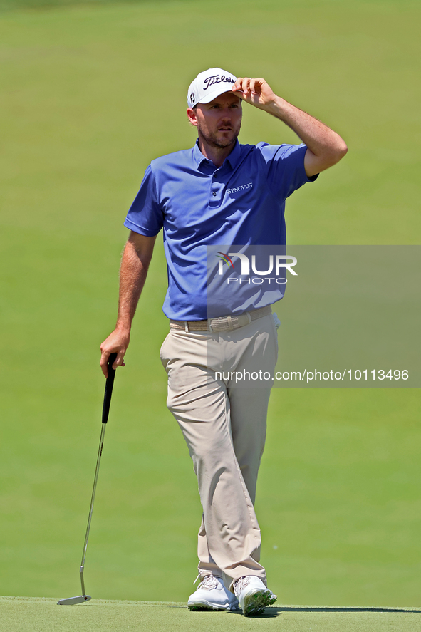 Russell Henley of Columbus, Georgia waits on the 18th green during the first round of the The Memorial Tournament presented by Workday at Mu...