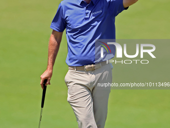 Russell Henley of Columbus, Georgia waits on the 18th green during the first round of the The Memorial Tournament presented by Workday at Mu...