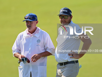 Matt NeSmith of Aiken, South Carolina waits with his caddie at the 18th green during the first round of the The Memorial Tournament presente...