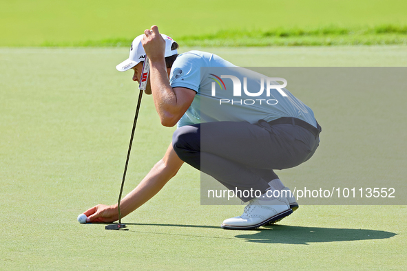 Thomas Detry of Brussels, Belgium places his ball on the 18th green during the first round of the The Memorial Tournament presented by Workd...