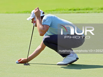 Thomas Detry of Brussels, Belgium places his ball on the 18th green during the first round of the The Memorial Tournament presented by Workd...