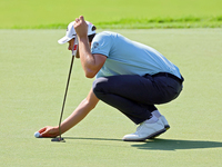 Thomas Detry of Brussels, Belgium places his ball on the 18th green during the first round of the The Memorial Tournament presented by Workd...