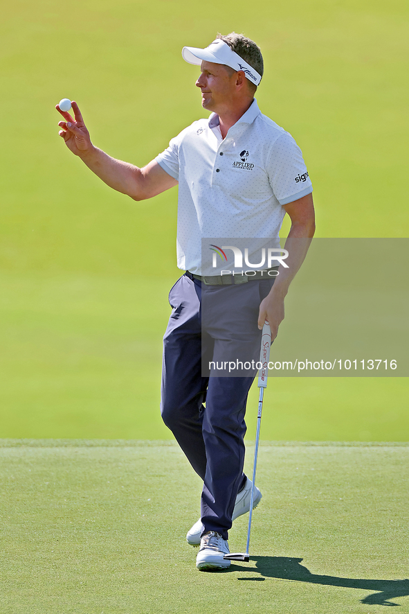 Luke Donald of England acknowledges the crowd after putting on the 18th green during the first round of the The Memorial Tournament presente...