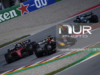 Max Verstappen of the Netherlands driving the (1) Oracle Red Bull Racing RB19 and Carlos Sainz of Spain driving (55) the Ferrari SF-23 durin...