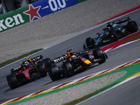 Max Verstappen of the Netherlands driving the (1) Oracle Red Bull Racing RB19 and Carlos Sainz of Spain driving (55) the Ferrari SF-23 durin...