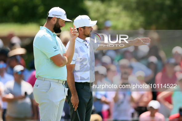 John Rahm of Barrika, Spain looks over the 7th green with Jason Day of Brisbane, Australia during  The Memorial Tournament presented by Work...