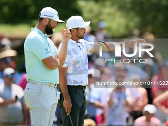 John Rahm of Barrika, Spain looks over the 7th green with Jason Day of Brisbane, Australia during  The Memorial Tournament presented by Work...