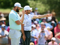 John Rahm of Barrika, Spain looks over the 7th green with Jason Day of Brisbane, Australia during  The Memorial Tournament presented by Work...