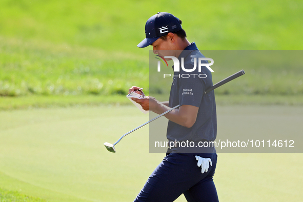 Justin Suh of San Jose, California marks his card as he walks off the 18th green after completing the  second round during  The Memorial Tou...