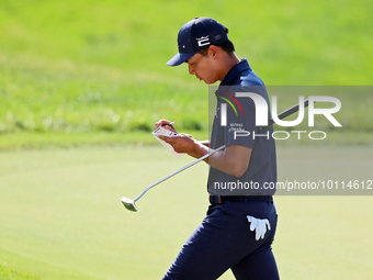 Justin Suh of San Jose, California marks his card as he walks off the 18th green after completing the  second round during  The Memorial Tou...