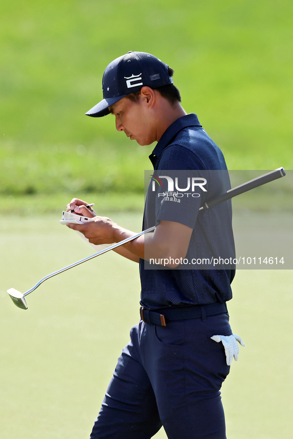 Justin Suh of San Jose, California marks his card as he walks off the 18th green after completing the  second round during  The Memorial Tou...