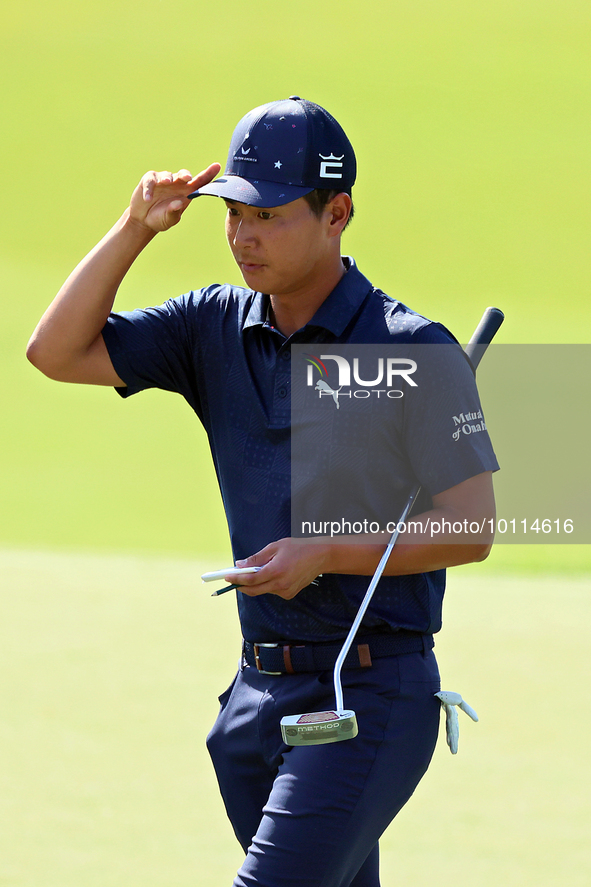 Justin Suh of San Jose, California acknowledges the fans as he walks off the 18th green after completing the  second round during  The Memor...